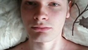 Masturbating in bed (only face visible)