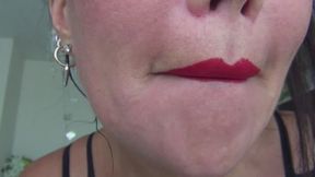 Red lip prints on a glass vase c