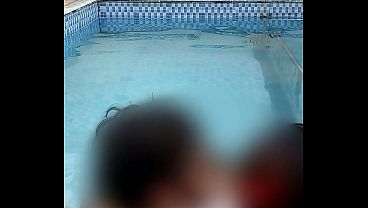 Couple makes out and enjoys a dip in the pool with their big butts touching.