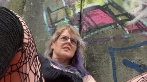 MILF fucks herself by busy mall