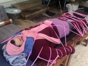 Wool mohair layers of sweaters on a bondage table
