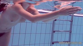 Hairy Lucy strips naked by the pool