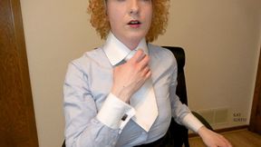 Woman taking off blue buttoned up shirt and white tie