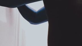 Shemale sucking a dildo wearing a shiny catsuit and a shiny leotard.