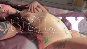 The tattooed girl shows you her big belly