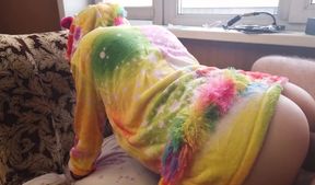 A baby in a unicorn costume shows off her ass