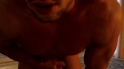 Muscular Guy in Poorly Lit Room Storking Cock for Camera