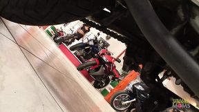 Two busty girls sneak in for a group sex session at the bike store