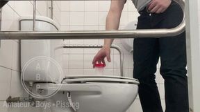 in the hospital toilets, a guy pisses into a cup for a urine sample, then gets horny, jerks-off and cums