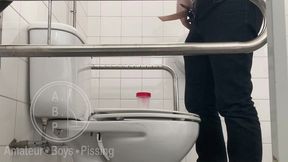 in the hospital toilets, a guy pisses into a cup for a urine sample, then gets horny, jerks-off and cums