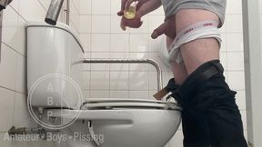 in the hospital toilets, a guy pisses into a cup for a urine sample, then gets horny, jerks-off and cums