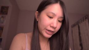 Asian solo girl studies bible while playing with her hair