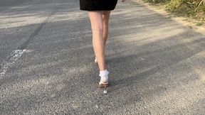 girl in snow-white socks and sandals walks, often loses a shoe and gets her socks very dirty