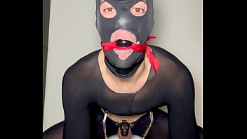 Sissy cross dresser strips in chastity while showing you his feet and slapping his balls