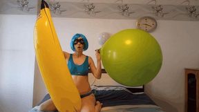 Irene inflates a balloon riding on a banana