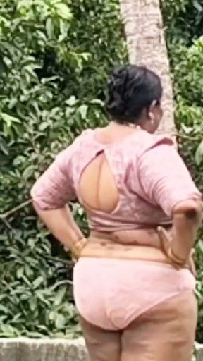 A Full-figured Woman in a White Skirt and Pink Top Strips Down and Walks Nude Outside