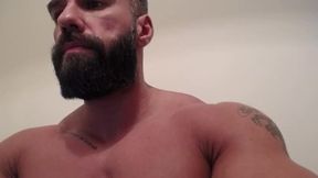 Bearded Muscled Man Flexes His Arms