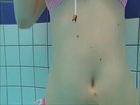 Cute girls in bikinis swimming and having fun in the pool