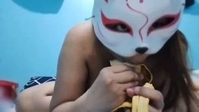 A busty Filipina girl is enjoying a banana slice while showing off her natural breasts and vagina.