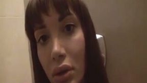 Lewd brunette shemale exposes her big boobies in the bathroom