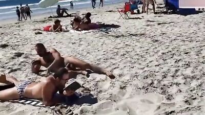 Two horny studs are having interracial gay sex action at the beach