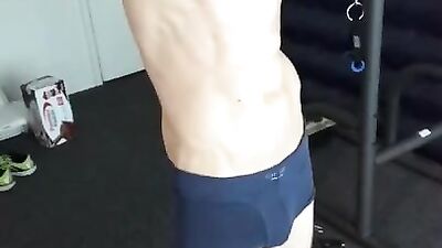 Horny guy is showing abs and touching cock in the gym