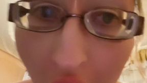 Girl in huge eyeglasses is yawning in the kitchen