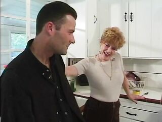 Younger chap gets blown by 70 year old redhead in kitchen