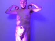 Man posing naked in a blue light his uncut cock shaved and flaccid shows off his nude body