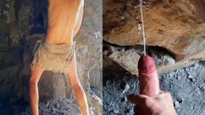 Neanderthal man masturbates his penis in a cave near a fire