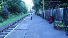 Crossdressed ooudoors on a public railway platform