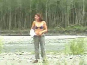 Curvaceous redhead girlfriend exposes her body over the river shore