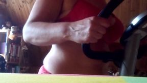 Sexy red lingerie on the exercise bike