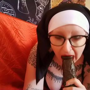 This nun sucks her BBC dildo