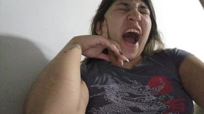 Lola yawns while smoking her cigarette