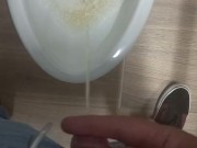 Peeing in a bathroom stall