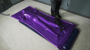 Butt flogging on a mattress in a purple vacuum bed
