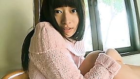 Lovely Asian girl Kaoru Goto takes her sweater off