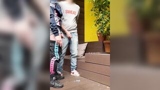 two guys attempt to urinate in a glass (one gets firm )