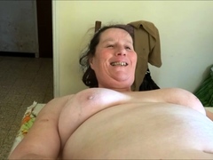 Chubby granny Annie on table - phone as sextoy close-up