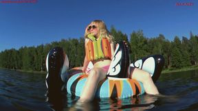 Alla floats on a bright inflatable swan on the lake and wears an inflatable vest for safety!!!