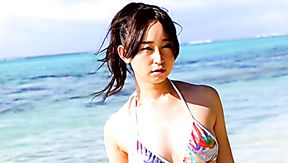 Lovely Asian girl Yumi Ishikawa swims in the ocean