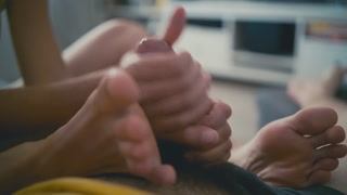 She makes him hard with her feet &amp; stroke it with 2 hands until he splashes cum on her sole