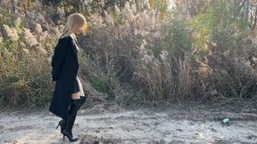 a girl walks in leather high boots, finds a watermelon and starts crushing it