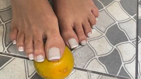 Squirting oranges with dirty feet for you to lick