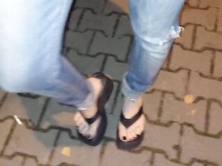 crossdresser with outstanding feet on a night walk in the park