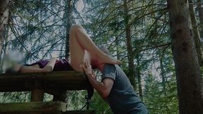 Passionate love making on a picnic table in forest