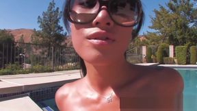 Asa Akira lays out by her pool and gets oiled up