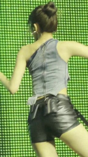 Female model in black shorts and tank top on runway