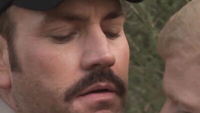 Naughty cop fucks that dude's face and barebacks him in the woods